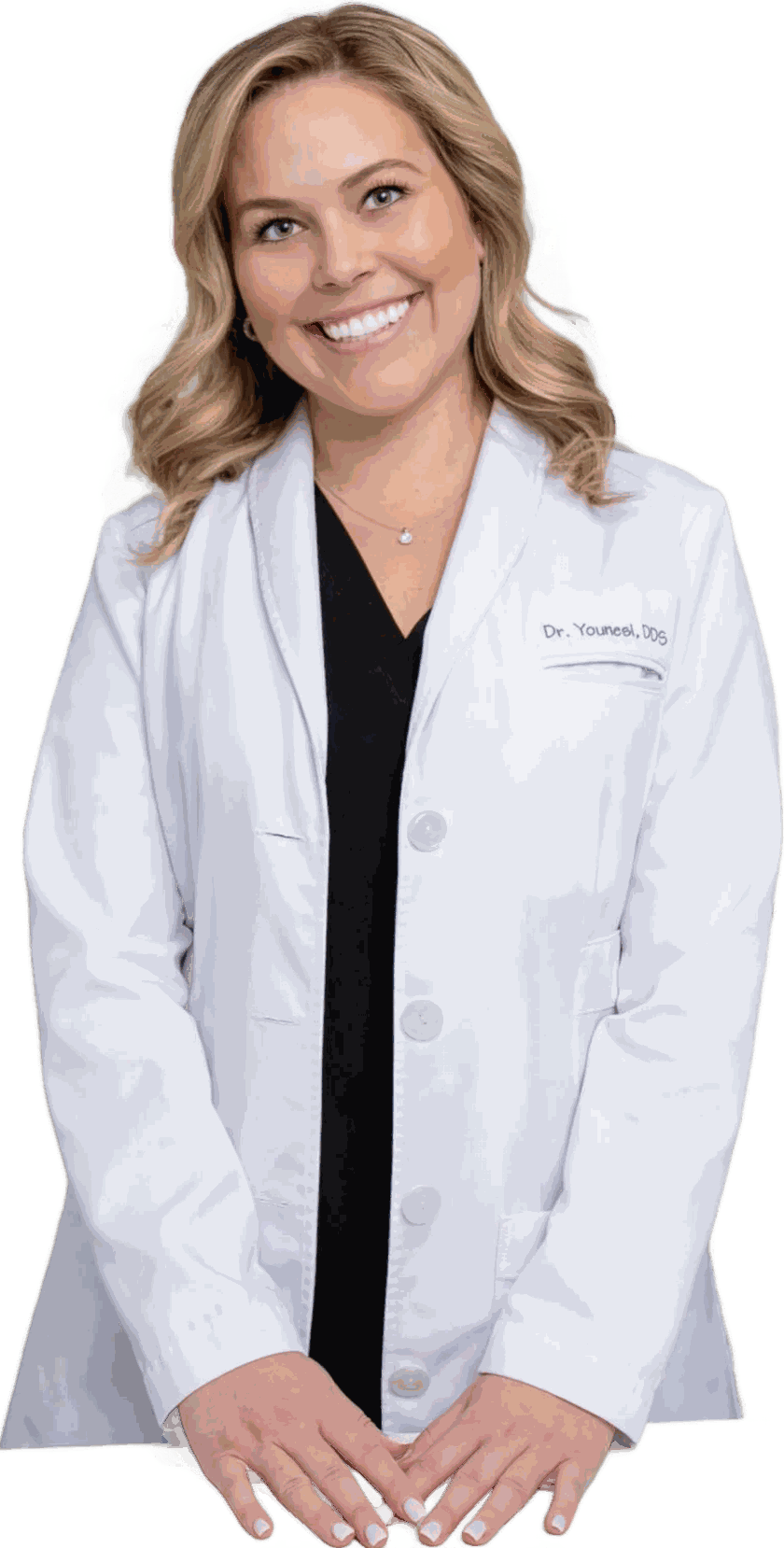 Dr. Jacqueline Younesi, DDS, in her white coat